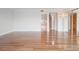 A brightly lit, empty living room featuring hardwood floors, neutral walls, and multiple entryways at 7550 Hinson St # 11C, Orlando, FL 32819