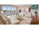 Inviting living room with plush seating, water views, and a stylish glass-top coffee table at 7550 Hinson St # 11C, Orlando, FL 32819