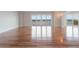 Spacious living room with hardwood floors and sliding glass doors to a balcony with scenic views at 7550 Hinson St # 11C, Orlando, FL 32819