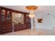 Bright living room with marble flooring, a chandelier, and a custom wall unit featuring a picturesque mural at 7550 Hinson St # 11C, Orlando, FL 32819