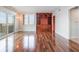 Hardwood living room featuring balcony access, an accent wall, and lots of natural light at 7550 Hinson St # 11C, Orlando, FL 32819