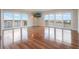 Bright living room featuring hardwood floors, a flat-screen TV, and sliding glass doors to a balcony with views at 7550 Hinson St # 11C, Orlando, FL 32819