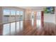 Bright living room with hardwood floors and balcony access offering picturesque views at 7550 Hinson St # 11C, Orlando, FL 32819
