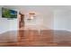 Bright open-concept living area with hardwood floors, a flat-screen TV, and elegant lighting at 7550 Hinson St # 11C, Orlando, FL 32819