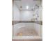 Beautiful tiled shower with glass enclosure and built-in seat at 7550 Hinson St # 11C, Orlando, FL 32819