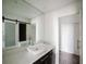 Modern bathroom featuring a vessel sink, quartz countertops, and a sliding barn door at 8322 Lake Lucy Dr, Orlando, FL 32818