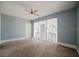 Bedroom with sliding glass doors leading to a balcony, providing a great view and natural light at 8322 Lake Lucy Dr, Orlando, FL 32818