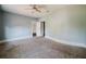 Bedroom featuring neutral walls and carpet, a ceiling fan and closet at 8322 Lake Lucy Dr, Orlando, FL 32818