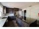Modern kitchen with an island, stainless steel appliances, and dark wood cabinets at 8322 Lake Lucy Dr, Orlando, FL 32818