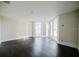 Bright living room with hardwood floors and large sliding glass doors leading to a balcony, perfect for enjoying the view at 8322 Lake Lucy Dr, Orlando, FL 32818