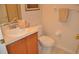 Bathroom features a sink with warm wood cabinetry and neutral colored walls at 913 Henley Cir, Davenport, FL 33896