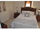 Comfortable bedroom with a cozy bed, dark wood furniture, and soft lighting, creating a relaxing and serene retreat at 913 Henley Cir, Davenport, FL 33896
