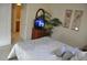 Tranquil bedroom with soft lighting, featuring a TV on a dresser and an open doorway to a bathroom at 913 Henley Cir, Davenport, FL 33896