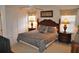 Bedroom boasts ceiling fan, and two bedside tables with lamps for a relaxing ambiance at 913 Henley Cir, Davenport, FL 33896