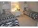 Bright bedroom featuring two beds, a nightstand, and a window with natural light at 913 Henley Cir, Davenport, FL 33896
