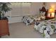 Cozy bedroom showcasing two twin beds with floral comforters and a wooden nightstand at 913 Henley Cir, Davenport, FL 33896