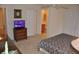 Bedroom boasts ensuite bathroom, ceiling fan, and a TV for added convenience at 913 Henley Cir, Davenport, FL 33896
