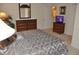 Bedroom features a mirrored dresser and a TV for ultimate comfort and entertainment at 913 Henley Cir, Davenport, FL 33896