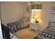 Bedroom featuring two twin beds, a ceiling fan and a window with blinds at 913 Henley Cir, Davenport, FL 33896