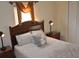 Inviting bedroom featuring a queen bed, classic wood furnishings, and soft, warm lighting for a comfortable and restful ambiance at 913 Henley Cir, Davenport, FL 33896
