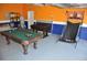 Spacious garage area with a pool table, foosball table, and basketball game at 913 Henley Cir, Davenport, FL 33896