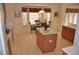 Open-concept kitchen with tile flooring, central island, and breakfast nook with bay window at 913 Henley Cir, Davenport, FL 33896
