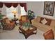 Cozy living room with large windows, comfortable seating, and tasteful decor at 913 Henley Cir, Davenport, FL 33896