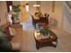 Comfortable living room and dining space with plush sofa, wooden furniture, and staircase at 913 Henley Cir, Davenport, FL 33896