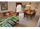 Inviting living room and dining area with neutral carpet, wooden furniture, and bright natural light at 913 Henley Cir, Davenport, FL 33896