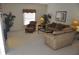 Bright living room with neutral carpet, comfortable sofas, and large windows for ample natural light, creating an inviting space at 913 Henley Cir, Davenport, FL 33896