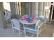 A round outdoor dining table with 4 chairs is located on the patio at 913 Henley Cir, Davenport, FL 33896