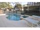 Tranquil screened in pool and spa area with lounge chairs to soak in the sun at 913 Henley Cir, Davenport, FL 33896