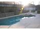 Screened in pool and spa are surrounded by chairs and overlook the backyard at 913 Henley Cir, Davenport, FL 33896