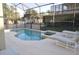 Tranquil screened in pool and spa area with lounge chairs to soak in the sun at 913 Henley Cir, Davenport, FL 33896