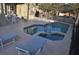 The private screened in pool and spa area complete with an outdoor dining table at 913 Henley Cir, Davenport, FL 33896