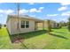 Exterior view showcasing the backyard with patio, young trees, and lush green lawn at 993 King Parc Rd, Orange City, FL 32763