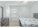 Bedroom with carpeted floor, gray accent wall, and ample natural light from the window at 993 King Parc Rd, Orange City, FL 32763