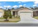 Charming single-Gathering home featuring a two-car garage and manicured front lawn at 993 King Parc Rd, Orange City, FL 32763