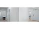 Bright foyer with white walls and trim along with neutral tile flooring and access to bedroom and laundry at 993 King Parc Rd, Orange City, FL 32763