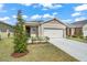 Well maintained single story home with green lawn, neutral colors, and a two car garage at 993 King Parc Rd, Orange City, FL 32763