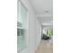 Bright hallway with a view into the living and dining area with neutral walls and tile flooring at 993 King Parc Rd, Orange City, FL 32763