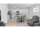 Bright kitchen featuring white cabinets, stainless appliances, and an adjacent dining area at 993 King Parc Rd, Orange City, FL 32763