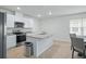 Well-lit kitchen showcasing an island, stainless steel appliances, and granite countertops at 993 King Parc Rd, Orange City, FL 32763