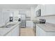Bright kitchen featuring stainless steel appliances, white cabinetry, and granite countertops at 993 King Parc Rd, Orange City, FL 32763