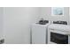 The laundry area features a white washer and dryer with white walls and trim at 993 King Parc Rd, Orange City, FL 32763