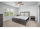 Comfortable bedroom featuring a queen bed, side tables, ceiling fan, and a window at 993 King Parc Rd, Orange City, FL 32763