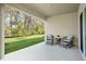 Covered patio featuring outdoor seating and a tranquil view of the backyard at 993 King Parc Rd, Orange City, FL 32763