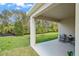 A covered patio with seating offers an outdoor living space and backyard views at 993 King Parc Rd, Orange City, FL 32763