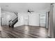 Spacious living area with modern floors, staircase, white walls, and natural light from large windows at 10012 Quail Meadow Aly, Winter Garden, FL 34787