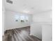 Bright living room with hardwood-style floors and ample light from multiple windows at 10012 Quail Meadow Aly, Winter Garden, FL 34787